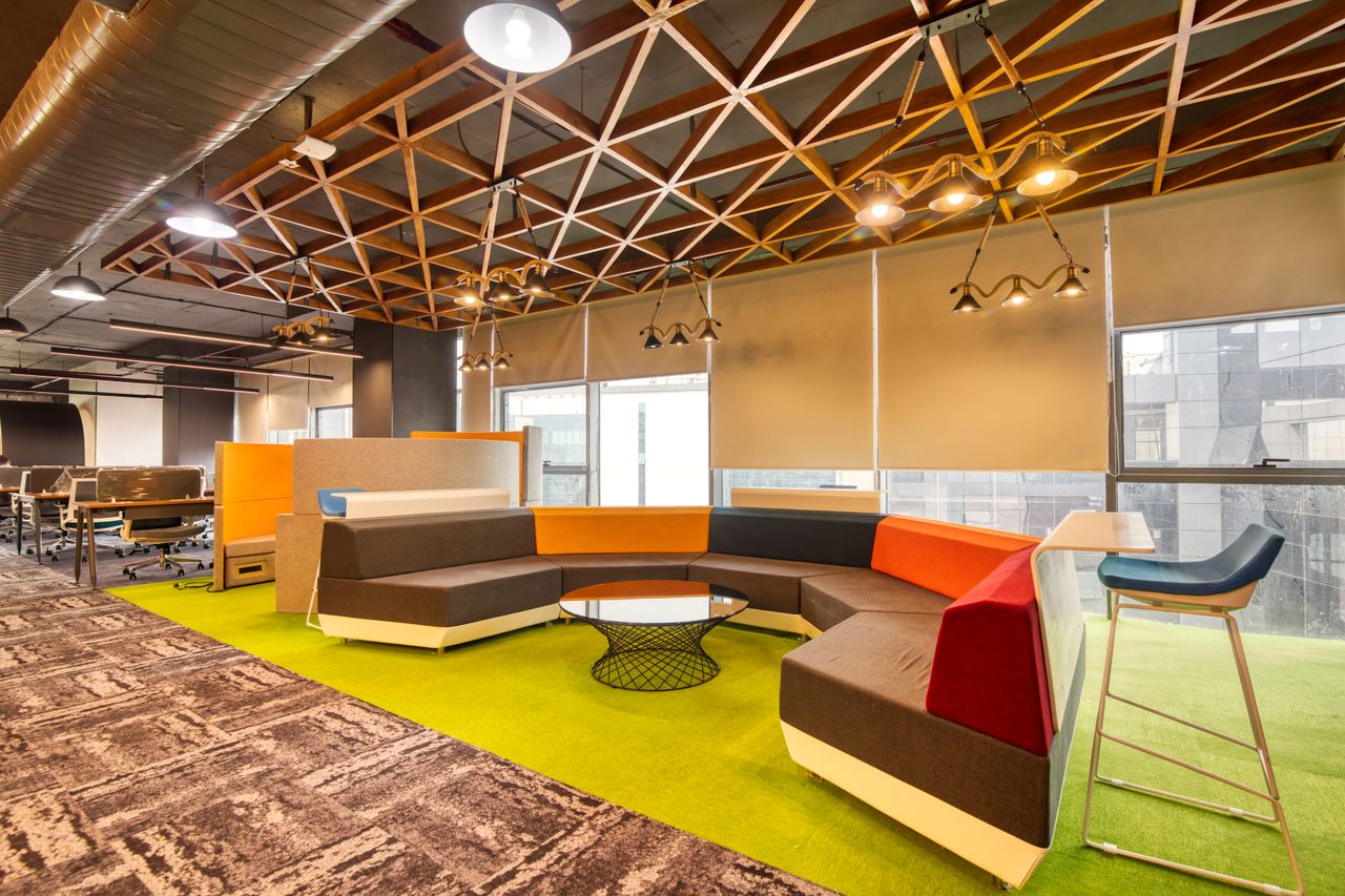 Mastering the First Impression: Your intriguing post title goes here Vibrant open office space with colorful seating and contemporary design elements.
